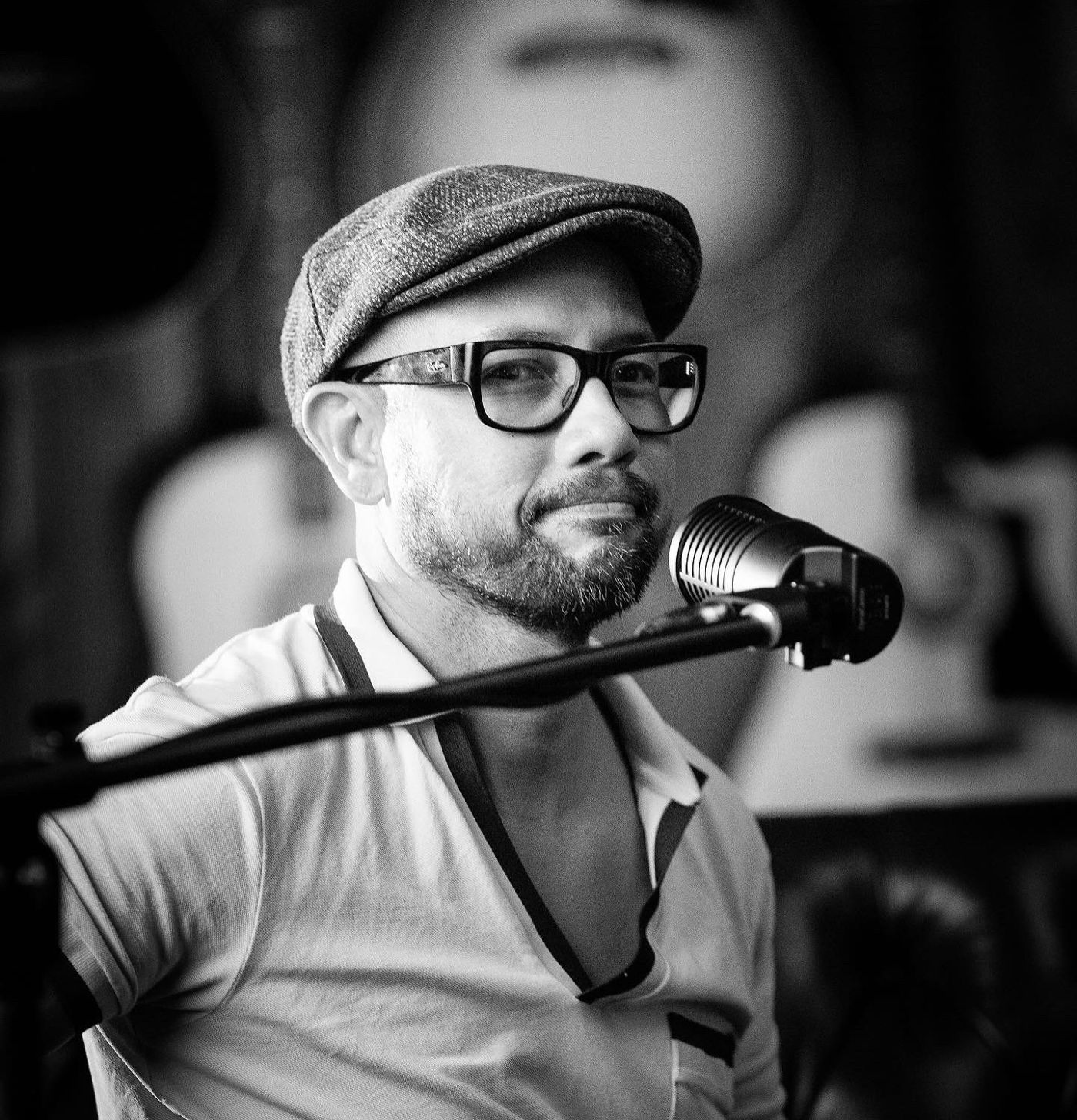 Black and white portrait of John at the microphone