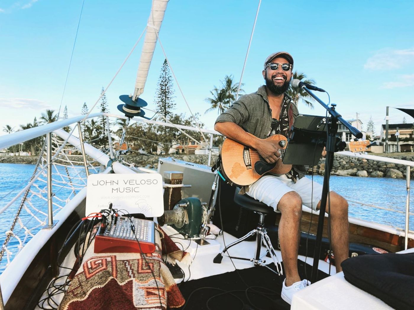 John performing on a sailing boat on the water